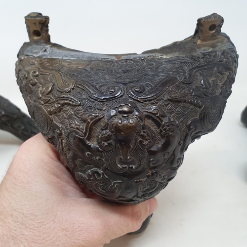 649 - A set of three Chinese bronze feet, decorated mythical beasts and foliage, 16 cm (3)