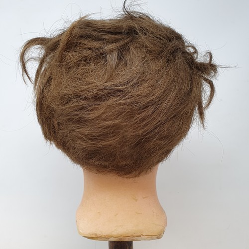 650 - A 19th century wax head, with glass eyes, on an ebonised stand, 40 cm high