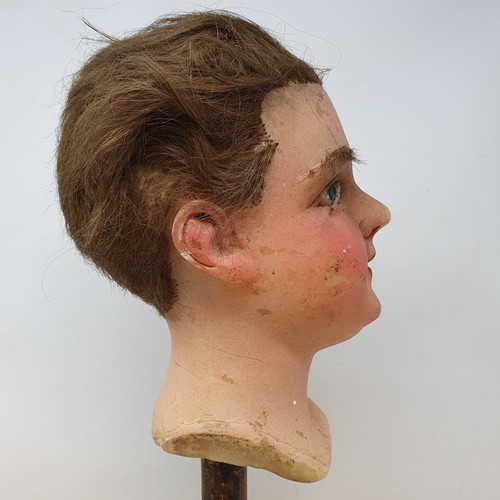 650 - A 19th century wax head, with glass eyes, on an ebonised stand, 40 cm high