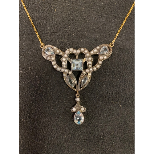 143 - A modern Art Nouveau style pendant necklace, inset with white and blue stones