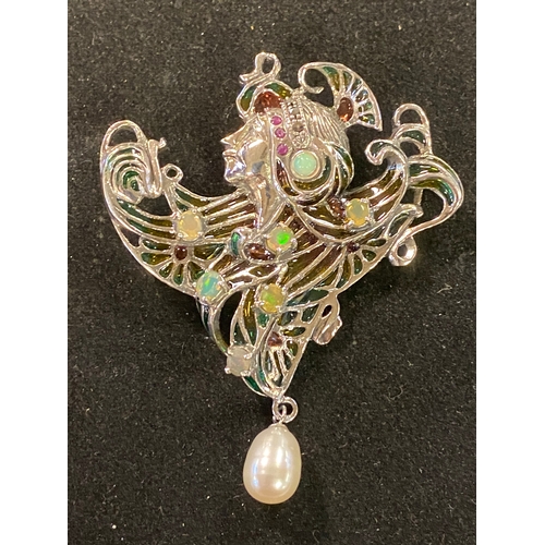 177 - An Art Nouveau style silver pendant/brooch, with opals, rubies and marcasite