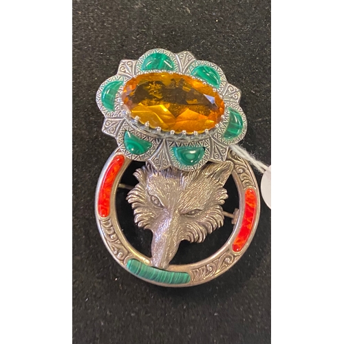 222 - A modern silver coloured metal brooch, inset with a yellow stone, another, embossed with a fox head ... 