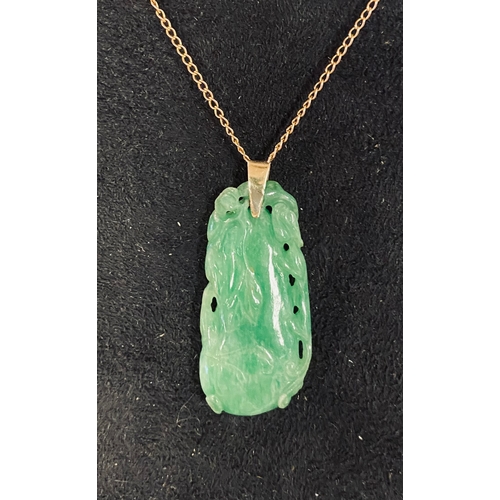 351 - A Chinese carved mutton fat jade pendant, 4 cm high, on a chain