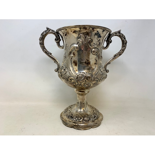 17 - A large Victorian silver two-handle trophy cup, with rococo style embossed decoration, London 1861, ... 