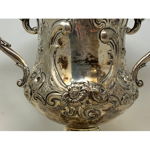 17 - A large Victorian silver two-handle trophy cup, with rococo style embossed decoration, London 1861, ... 