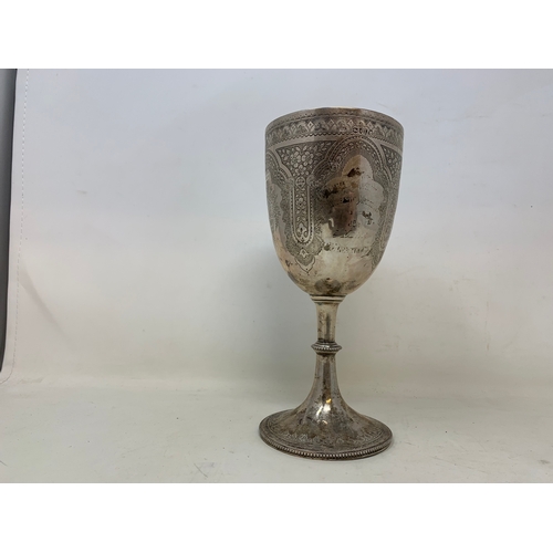 19 - A Victorian silver trophy goblet, indistinctly inscribed, and decorated flowers and foliage, London ... 