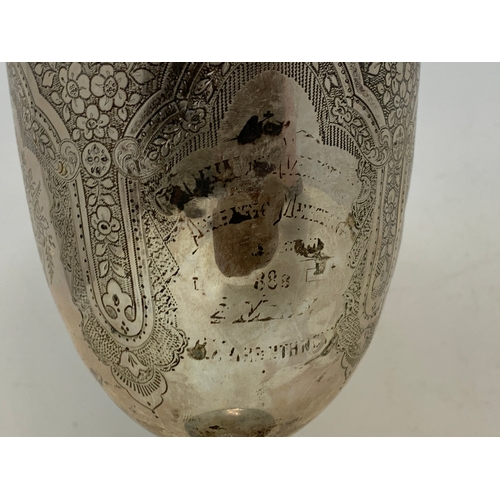 19 - A Victorian silver trophy goblet, indistinctly inscribed, and decorated flowers and foliage, London ... 