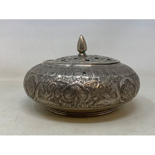 27 - A Persian silver coloured metal pot pourri bowl and cover, decorated flowers and foliage, 19 cm diam... 