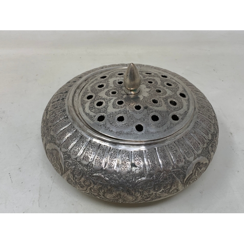 27 - A Persian silver coloured metal pot pourri bowl and cover, decorated flowers and foliage, 19 cm diam... 