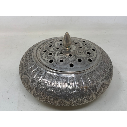 27 - A Persian silver coloured metal pot pourri bowl and cover, decorated flowers and foliage, 19 cm diam... 