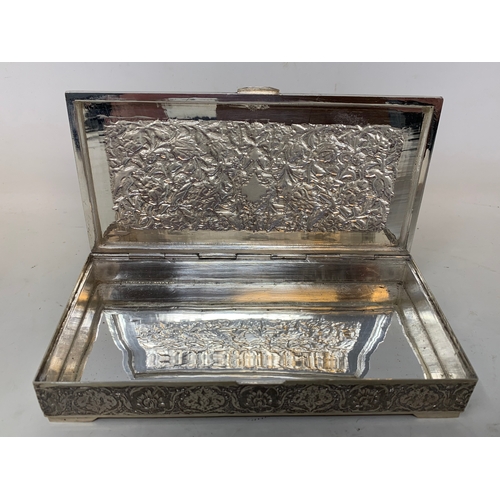 29 - A Persian silver coloured metal table cigarette box, decorated birds, flowers and foliage, 16 cm wid... 