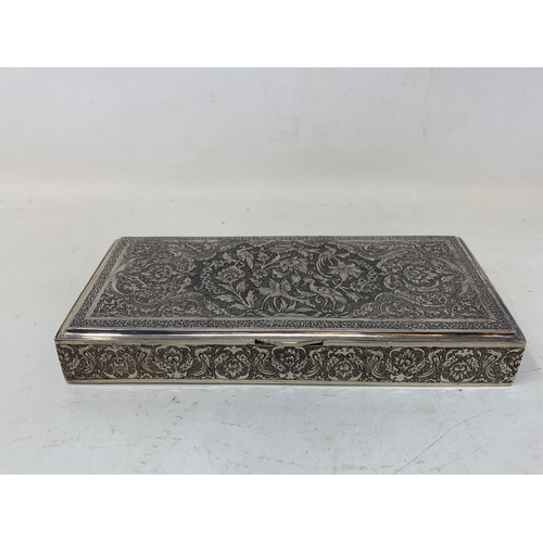 30 - A Persian silver coloured metal table cigarette box, decorated birds, flowers and foliage, 16.5 cm w... 