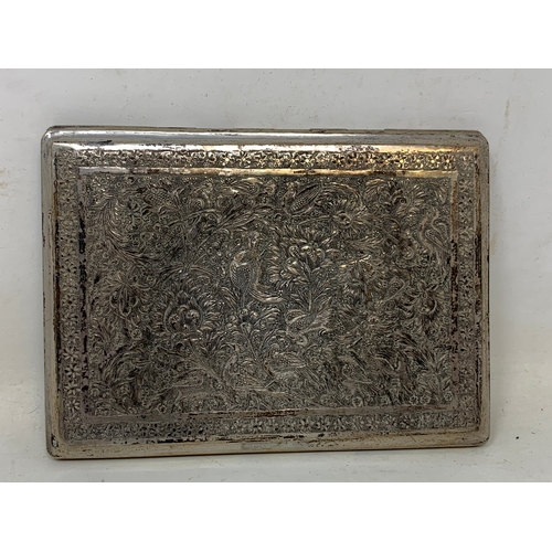 31 - A Persian silver coloured metal cigarette case, decorated birds, flowers and foliage, 11.5 cm wide