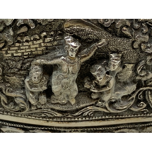 36 - A Burmese style silver coloured metal bowl, embossed figures and foliage, dented and holed, 13 cm di... 