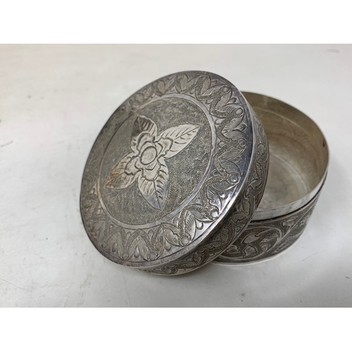 37 - A Malaysian style silver coloured metal leaf shaped dish, 19 cm wide, a similar silver coloured meta... 