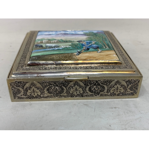 40 - A Persian silver coloured metal cigarette box, decorated a labourer digging, 8.5 cm wide