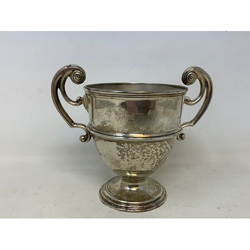 45 - A silver two handle trophy cup, London 1906, 7.7 ozt, 12 cm high