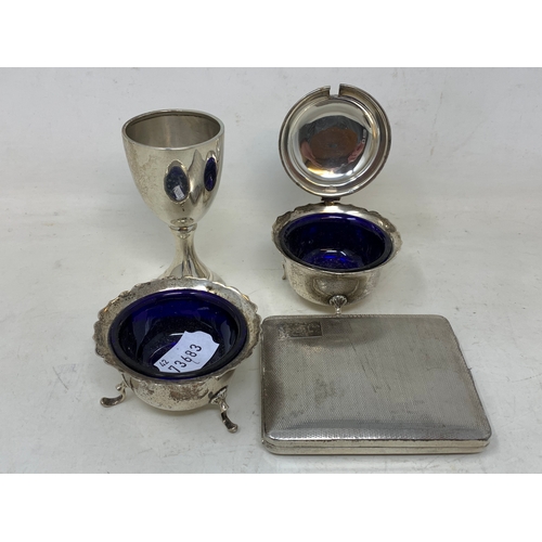 49 - A silver cigarette case, two silver condiments, and a small silver trophy cup, 8.8 ozt