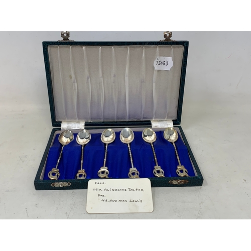 50 - A set of six Egyptian silver coloured metal teaspoons, with camel and crescent finials, cased