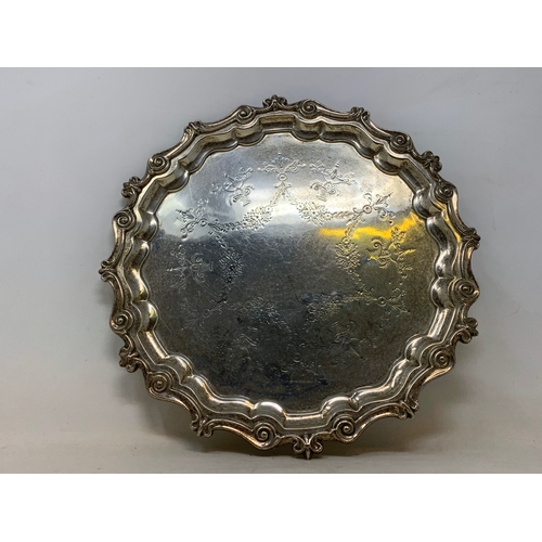 52 - An 18th century style silver salver, engraved foliage and swags, marks rubbed, 18.8 ozt, 28.5 cm dia... 