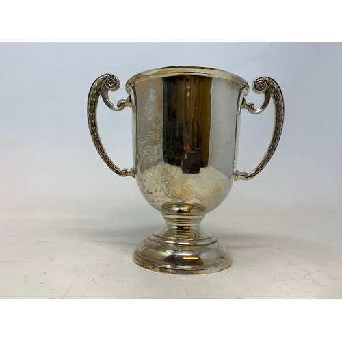 57 - A silver two handle trophy cup, Birmingham 1934, 9.3 ozt, 6.5 cm high