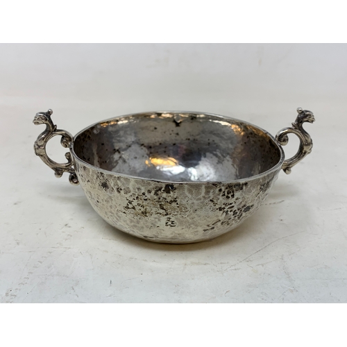 58 - A Continental silver coloured metal two handle bowl, of hammered form, 13 cm wide