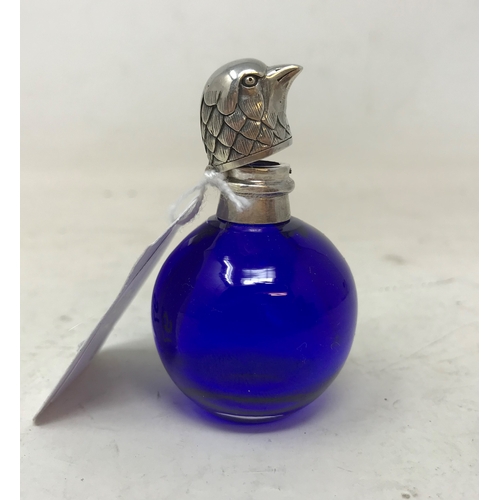 97 - A modern blue glass scent bottle, with mounts in the form of a bird's head, 5 cm high