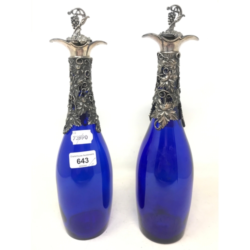 643 - A pair of modern blue glass and decanters, with grape and vine plated mounts, 34 cm high (2)