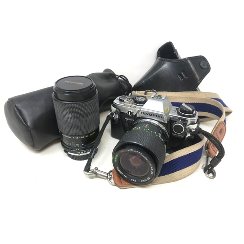 662 - An Olympus OM10 camera, with a spare lense (2)