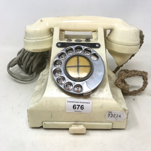 676 - A white Bakelite spin dial telephone