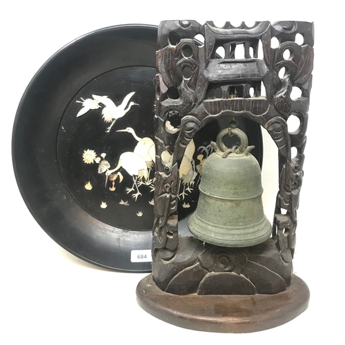 684 - A Chinese bronze bell, in a carved and pierced hardwood frame, 37 cm high, on a later base, and a Ja... 