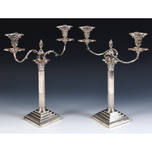 1 - A pair of late Victorian silver Corinthian column table candelabra, with stepped square bases and be... 