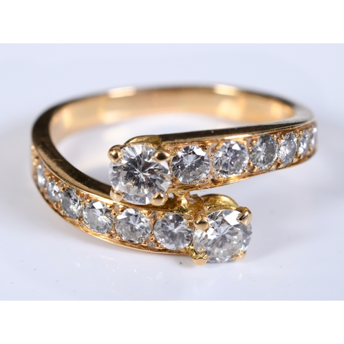 197 - A yellow coloured metal crossover ring, set two rows of seven graduated diamonds, approx. ring size ... 