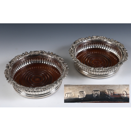 4 - A pair of early 19th century Scottish silver wine coasters, with rococo style edges, a reeded lower ... 