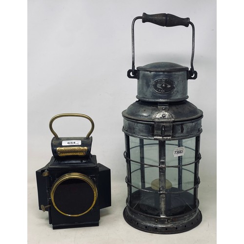654 - An Oldfield Dependence lamp 23 cm high, and a Griffiths lamp, 42 cm high (2)