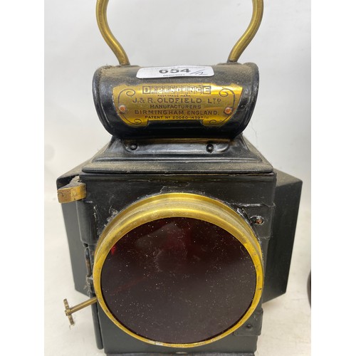 654 - An Oldfield Dependence lamp 23 cm high, and a Griffiths lamp, 42 cm high (2)
