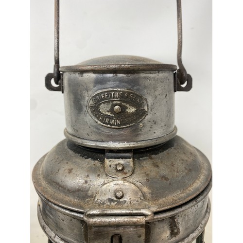 654 - An Oldfield Dependence lamp 23 cm high, and a Griffiths lamp, 42 cm high (2)