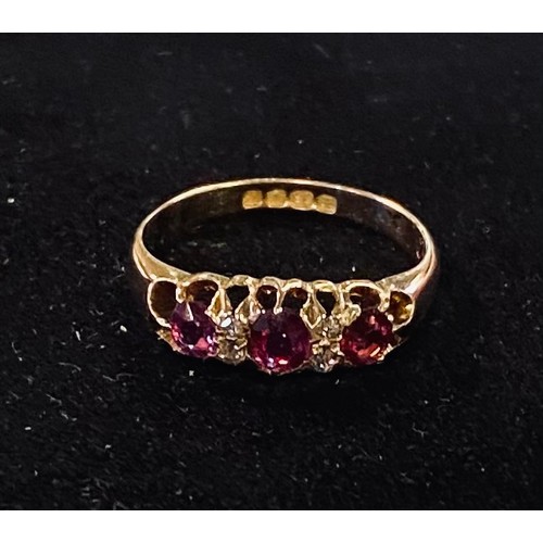 153 - An 18ct gold, ruby and diamond chip ring, approx. ring size L