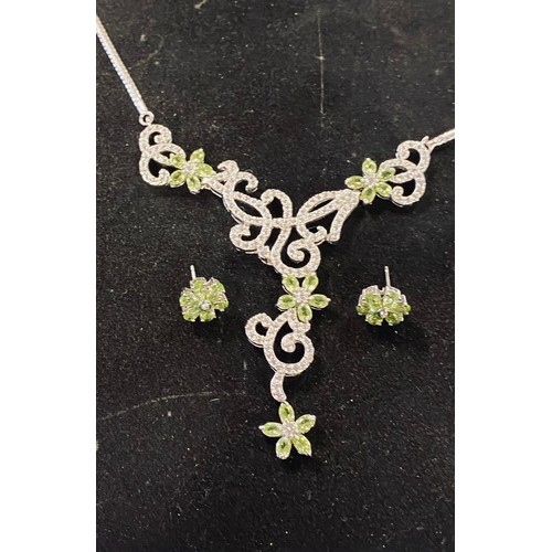 237 - A silver and peridot necklace, with matching earrings