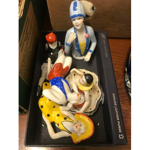 306 - A modern porcelain pincushion head, and four other similar figures (5)