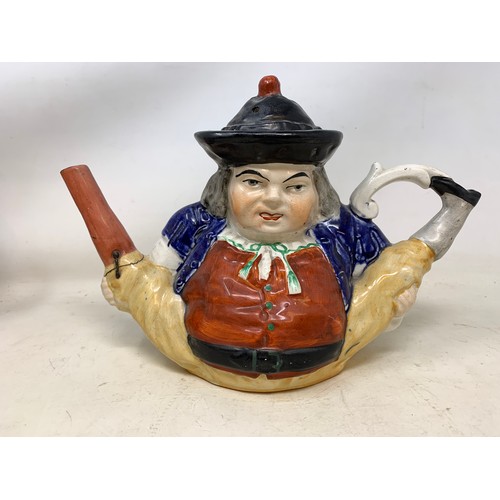 310 - A 19th century Staffordshire figure, 15 cm high, a similar teapot, spout repaired, a Continental dru... 