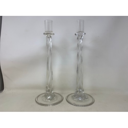 324 - A pair of glass candlesticks, with twisted stems, on circular bases, 39 cm high