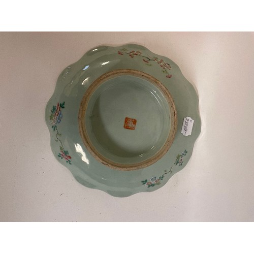 660 - A Chinese famille rose low comport, decorated birds and foliage on a celadon ground, 27 cm diameter,... 