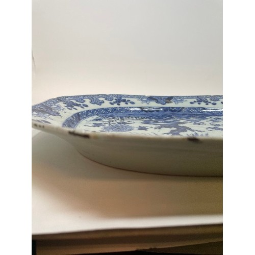 653 - An early 19th century Chinese meat plate, decorated flowers and foliage in underglaze blue, rim chip... 