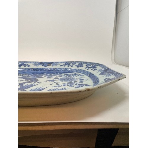 653 - An early 19th century Chinese meat plate, decorated flowers and foliage in underglaze blue, rim chip... 