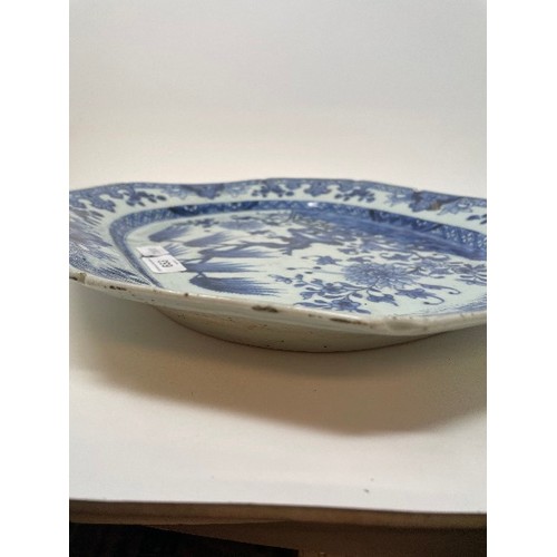 653 - An early 19th century Chinese meat plate, decorated flowers and foliage in underglaze blue, rim chip... 