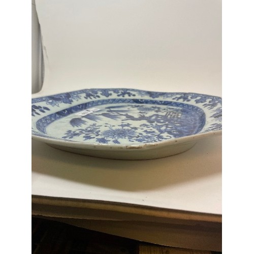 653 - An early 19th century Chinese meat plate, decorated flowers and foliage in underglaze blue, rim chip... 