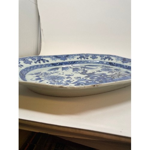 653 - An early 19th century Chinese meat plate, decorated flowers and foliage in underglaze blue, rim chip... 