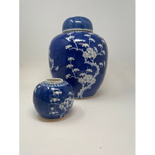 655 - A large Chinese ginger jar, decorated blossom, with associated cover, 29 cm high, and another ginger... 