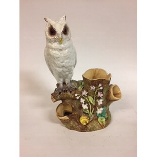 603 - A Moore Brothers figure of a long eared owl, perched on a branch, impressed mark to base, 33 cm high